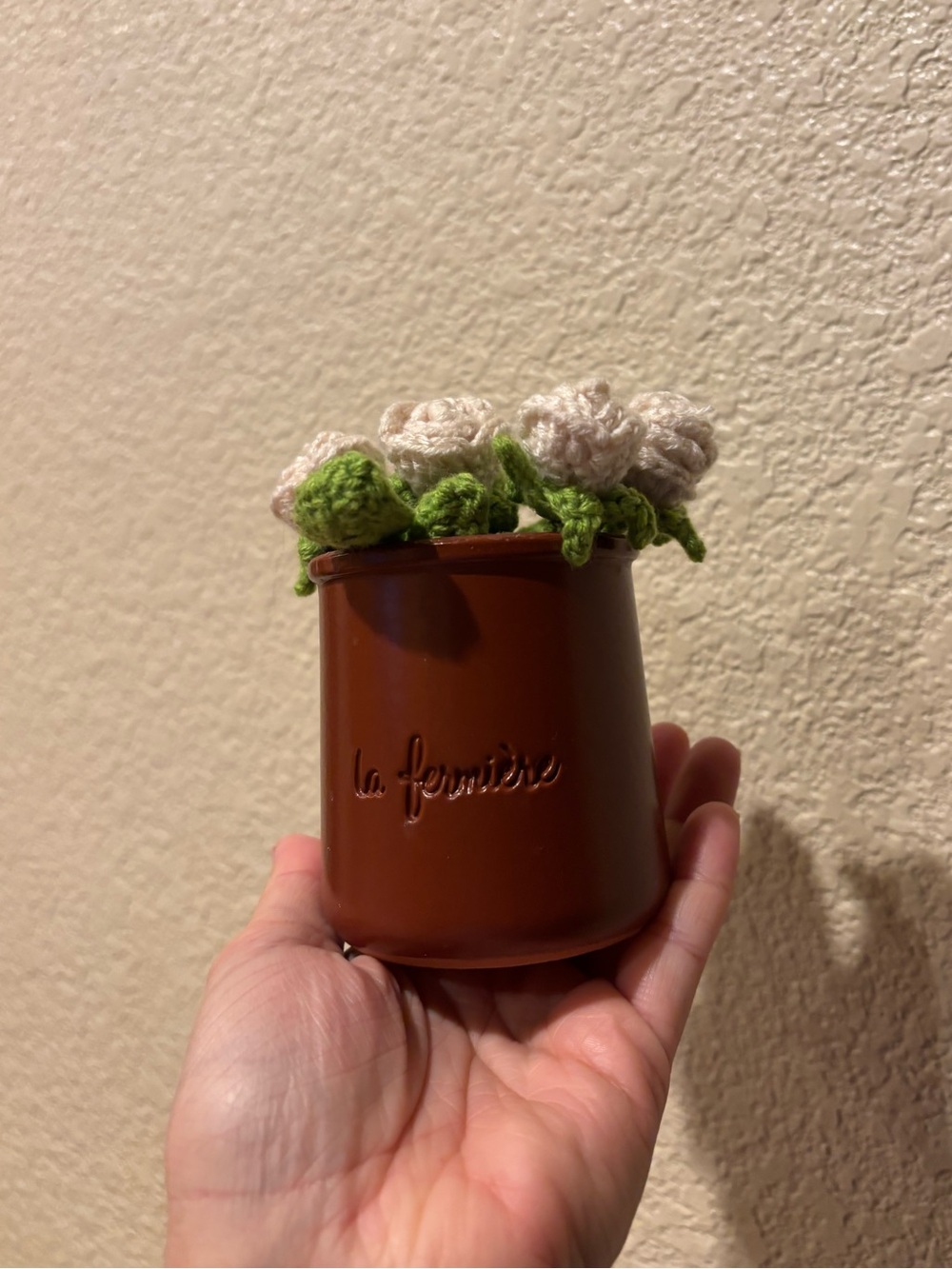 Crochet white roses in a brown pot